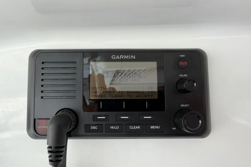 Slide: The Image of Garmin marine radio on 2023 Beneteau Antares 11 OB, featuring distress and communication controls. - 48