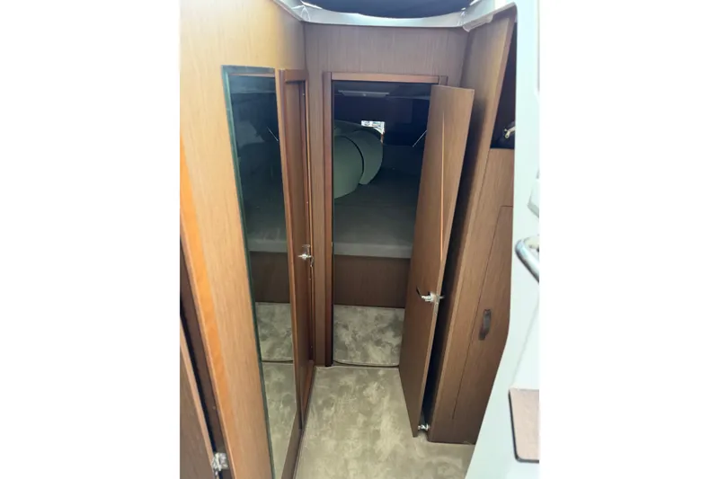 Slide: The Image of Interior cabin view of 2023 Beneteau Antares 11 OB with wooden doors and carpeted floor. - 53