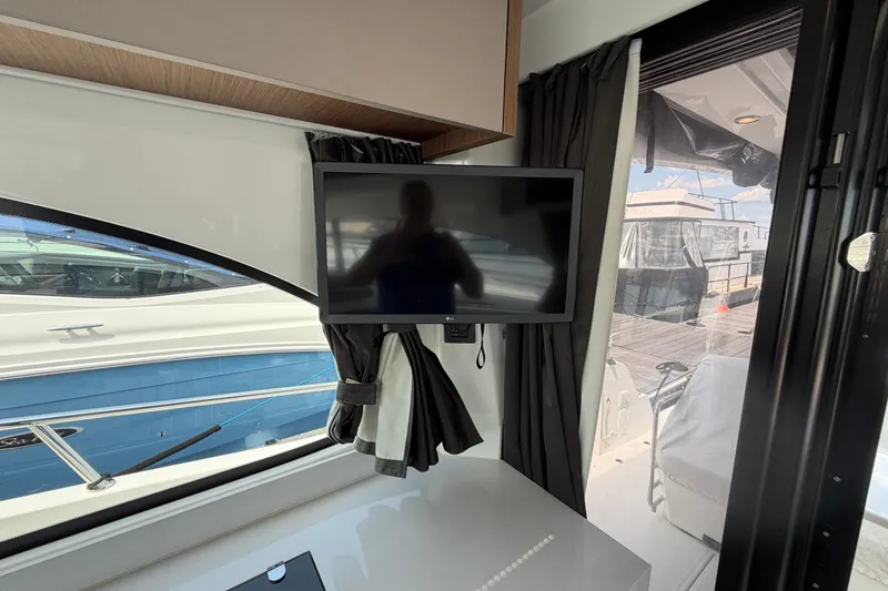 Slide: The Image of Interior view of 2023 Beneteau Antares 11 OB yacht with mounted TV and window. - 88