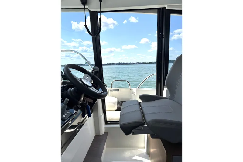 Slide: The Image of Interior view of 2023 Beneteau Antares 11 OB boat cockpit with steering wheel and seat. - 38