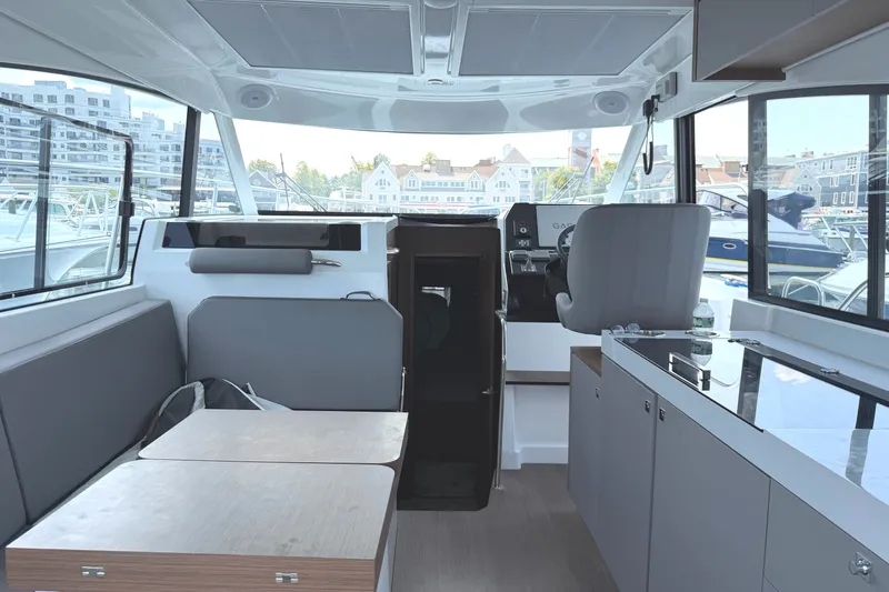 Slide: The Image of Interior of 2023 Beneteau Antares 11 OB boat, featuring modern seating and helm station. - 16