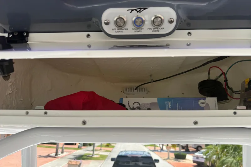 Slide: The Image of Storage compartment in a 2022 Tidewater 2410 Bay Max boat with control panel. - 32