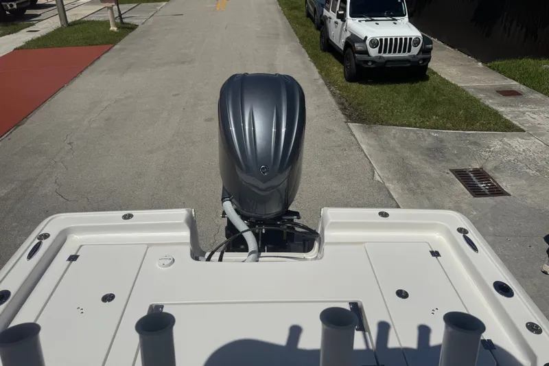 Slide: The Image of 2022 Tidewater 2410 Bay Max boat with outboard motor on a street. - 10