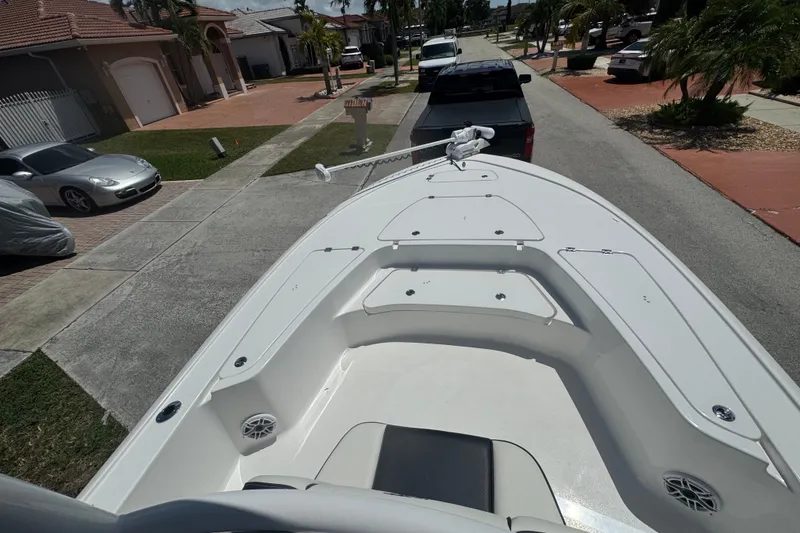 Slide: The Image of 2022 Tidewater 2410 Bay Max boat parked in a residential neighborhood driveway. - 35