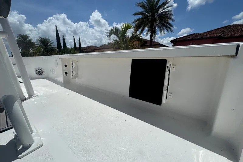 Slide: The Image of 2022 Tidewater 2410 Bay Max boat interior with clear sky and palm trees. - 15