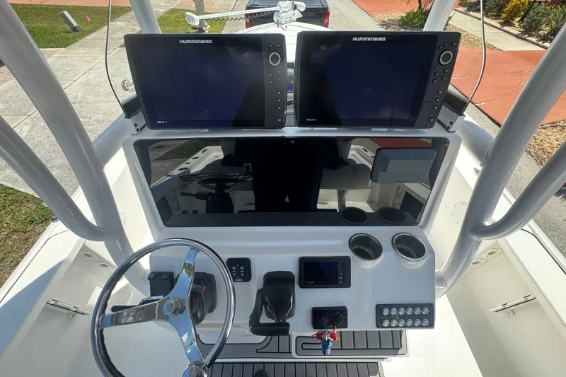 Slide: The Image of 2022 Tidewater 2410 Bay Max boat console with dual Humminbird displays and steering wheel. - 19
