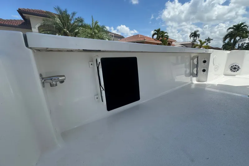 Slide: The Image of 2022 Tidewater 2410 Bay Max boat interior with storage compartment and speaker. - 14