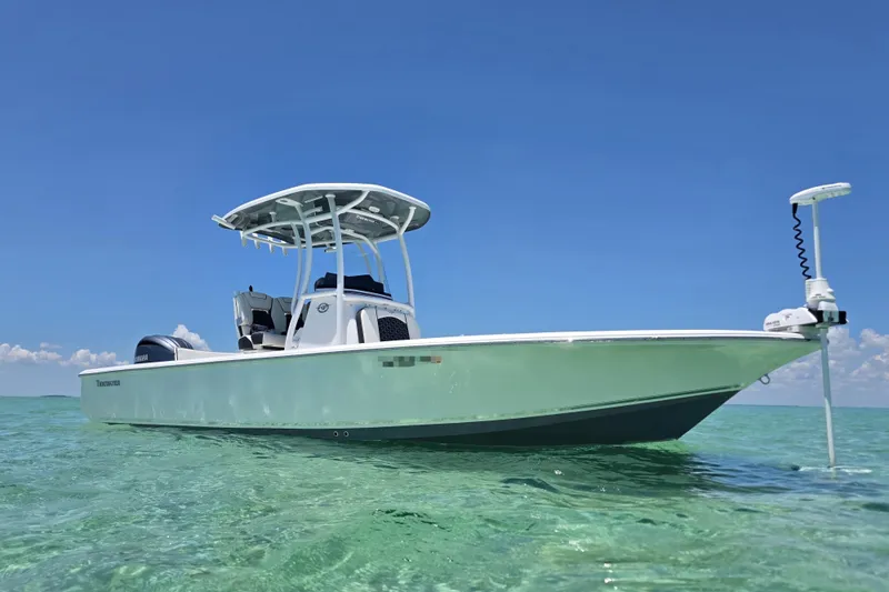 The Image of 2022 Tidewater 2410 Bay Max boat on clear water under blue sky. - 0