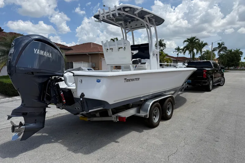 Slide: The Image of 2022 Tidewater 2410 Bay Max boat on trailer with Yamaha engine, parked on sunny street. - 7
