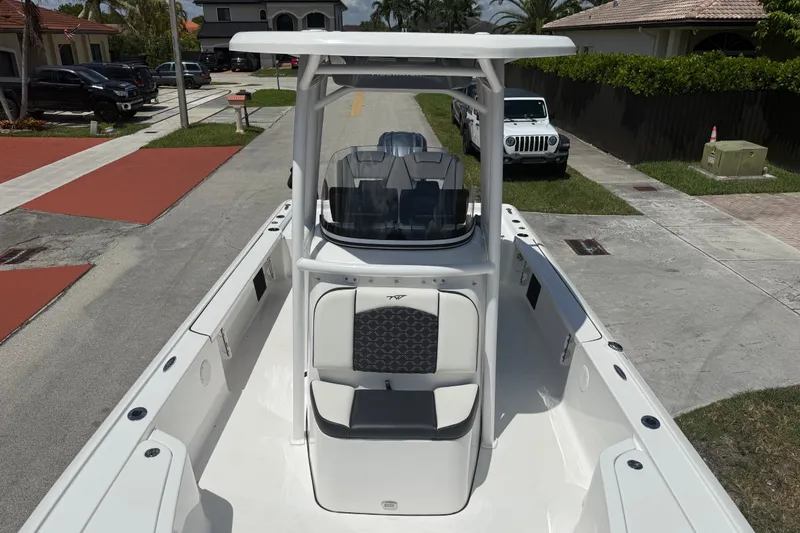 Slide: The Image of 2022 Tidewater 2410 Bay Max boat parked in a residential driveway. - 16