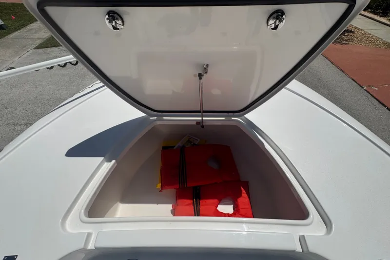 Slide: The Image of Open storage compartment on 2022 Tidewater 2410 Bay Max boat with life jackets inside. - 43