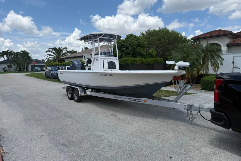 Slide: The Image of 2022 Tidewater 2410 Bay Max boat on trailer in suburban neighborhood. - 6