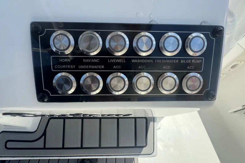 Slide: The Image of Control panel of a 2022 Tidewater 2410 Bay Max boat with labeled buttons. - 27