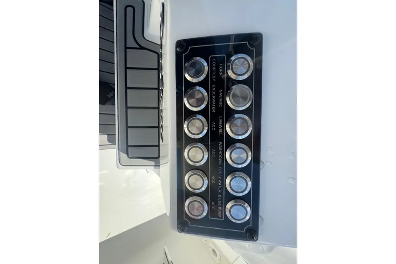 Slide: The Image of Control panel of a 2022 Tidewater 2410 Bay Max boat with labeled buttons. - 27