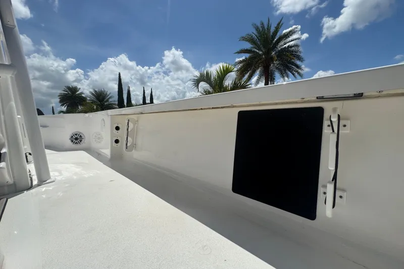Slide: The Image of Tidewater 2410 Bay Max 2022 boat deck under sunny sky with palm trees. - 13