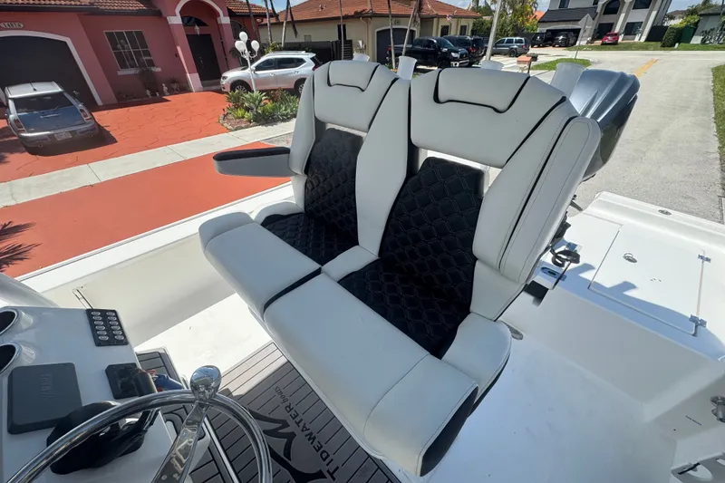Slide: The Image of Tidewater 2410 Bay Max 2022 boat with dual white and black cushioned seats. - 33