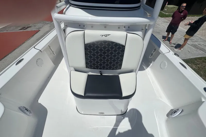 Slide: The Image of 2022 Tidewater 2410 Bay Max boat interior with cushioned seating and deck view. - 17