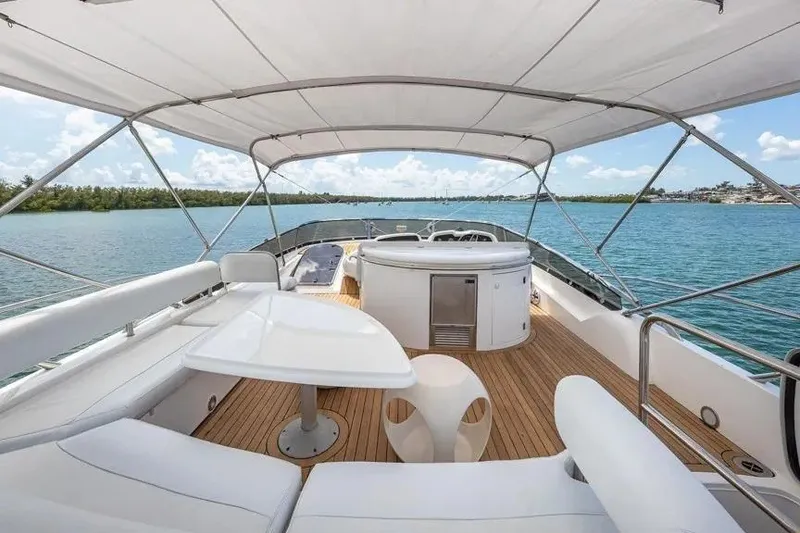 Slide: The Image of Luxurious Sunseeker Manhattan 74 yacht deck with seating, table, and ocean view. - 19