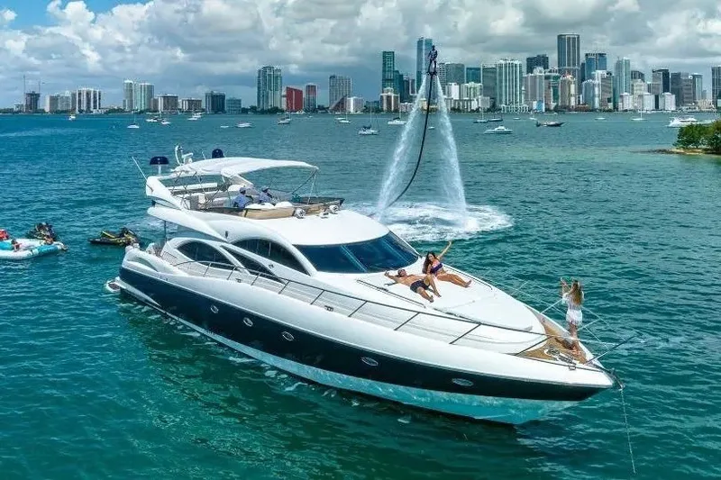 Slide: The Image of Luxurious 2000 Sunseeker Manhattan 74 yacht cruising near a vibrant city skyline. - 44