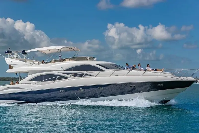 The Image of Luxury Sunseeker Manhattan 74 yacht cruising on blue ocean under clear sky. - 1