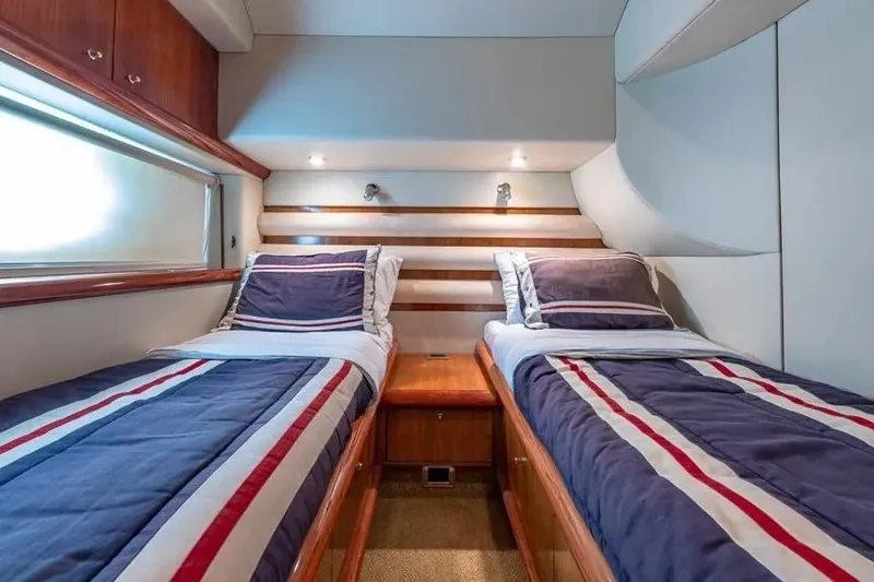 Slide: The Image of Twin cabin in 2000 Sunseeker Manhattan 74 yacht with striped bedding and wood accents. - 37