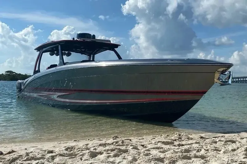 Slide: The Image of 2021 Concept 44' Open Deck boat on sandy shore under blue sky. - 30