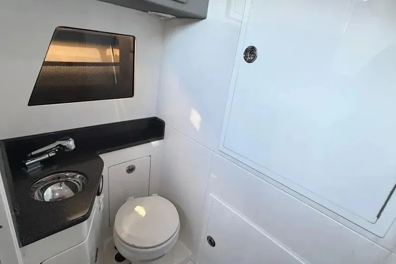 Slide: The Image of Modern bathroom interior on 2021 Concept 44' Open Deck boat, featuring sleek fixtures and storage. - 53