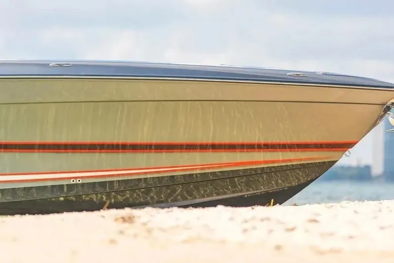 Slide: The Image of Concept 44' Open Deck boat, 2021 model, on sandy beach with city skyline background. - 58