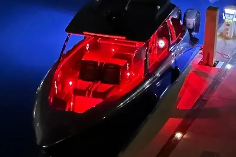 Slide: The Image of Sleek 2021 Concept 44' Open Deck boat with vibrant red interior lighting at night. - 45