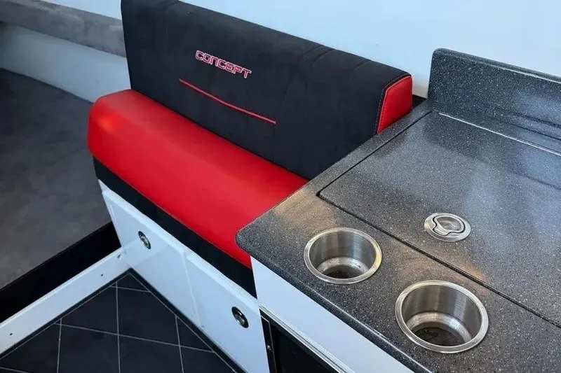 Slide: The Image of Red and black seating with a sleek countertop in a 2021 Concept 44' Open Deck. - 54