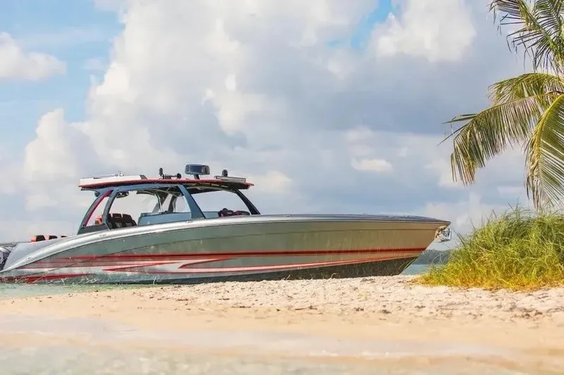 Slide: The Image of 2021 Concept 44' Open Deck boat on sandy beach with palm tree and cloudy sky. - 61
