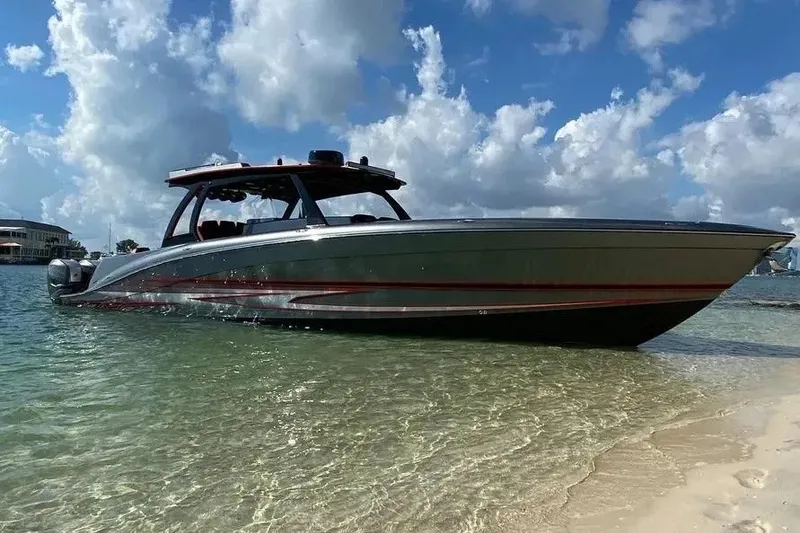 Slide: The Image of 2021 Concept 44' Open Deck boat on clear water near sandy shore. - 22
