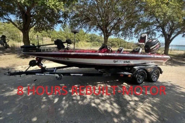 The Image of 2018 Phoenix 819 Pro boat with rebuilt motor, parked on a trailer under trees. - 0