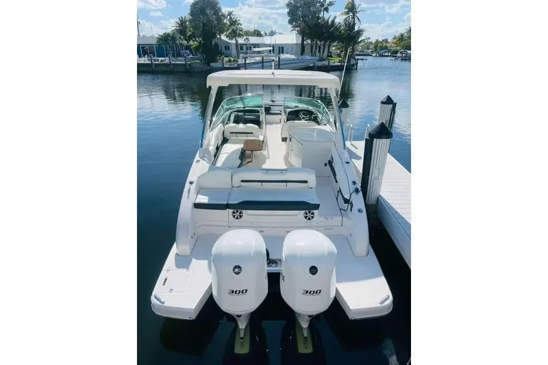 Slide: The Image of 2017 Regal 33 OBX boat docked, featuring dual outboard engines. - 6