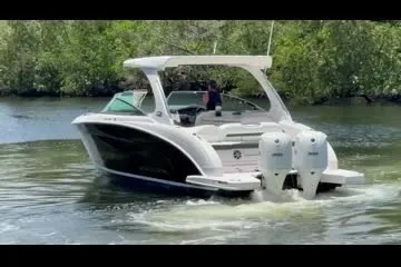 Slide: The Image of 2017 Regal 33 OBX boat cruising on a calm river surrounded by lush greenery. - 3