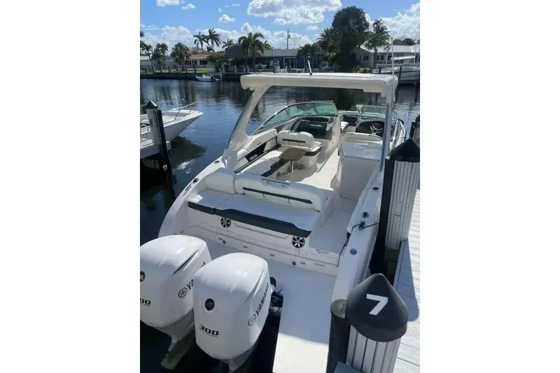 Slide: The Image of 2017 Regal 33 OBX boat docked, featuring dual Yamaha 300 engines, under a sunny sky. - 7