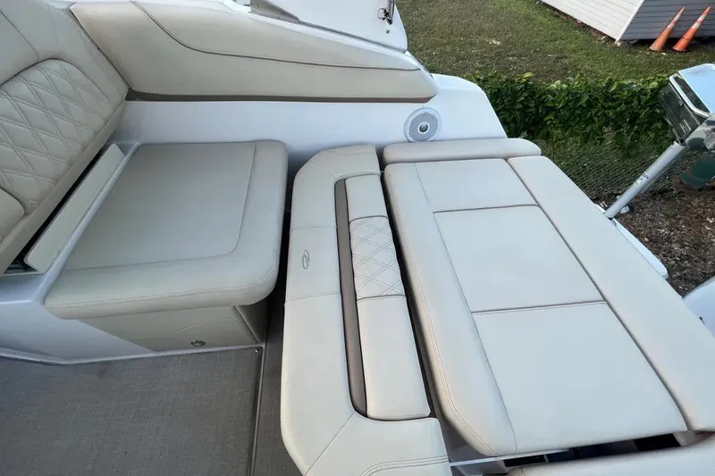 Slide: The Image of 2020 Regal 26 XO boat interior with beige cushioned seating and elegant design. - 25