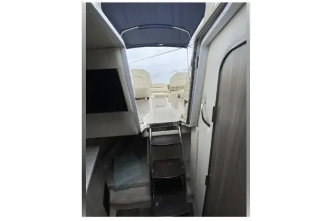 Slide: The Image of Interior view of 2020 Regal 26 XO boat, featuring cabin and seating area. - 41