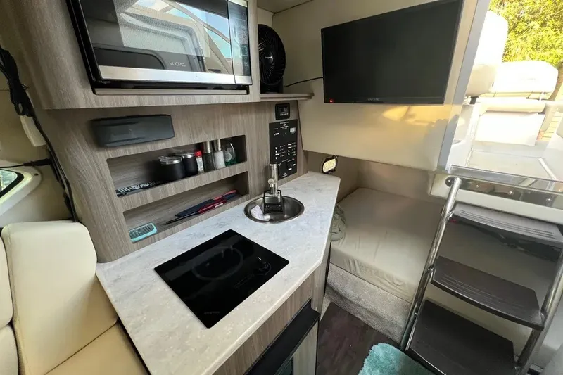 Slide: The Image of Compact interior of 2020 Regal 26 XO boat with kitchenette and seating area. - 36