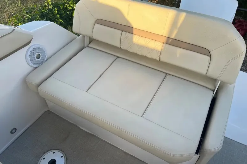 Slide: The Image of 2020 Regal 26 XO boat interior with beige cushioned seating and speaker. - 21