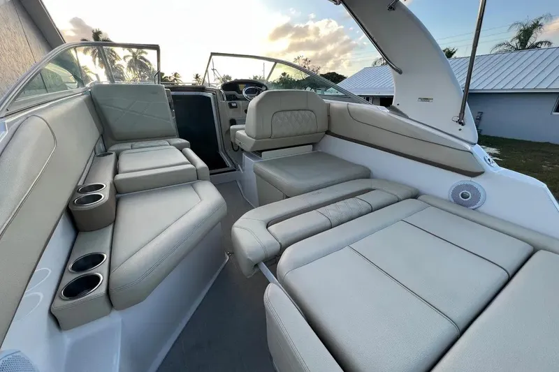 Slide: The Image of Interior of a 2020 Regal 26 XO boat with luxurious seating and cup holders. - 18