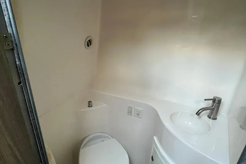 Slide: The Image of Compact bathroom in 2020 Regal 26 XO boat with modern sink and toilet. - 44