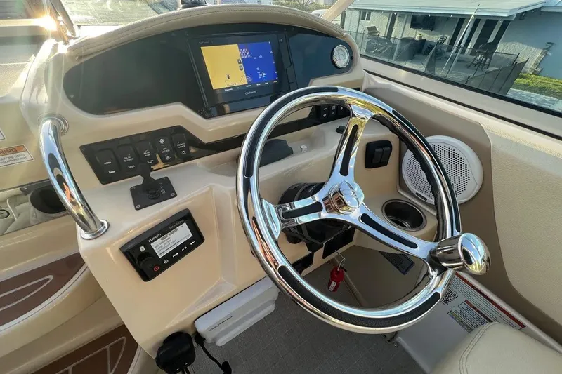 Slide: The Image of Helm of 2020 Regal 26 XO boat with steering wheel and navigation display. - 15