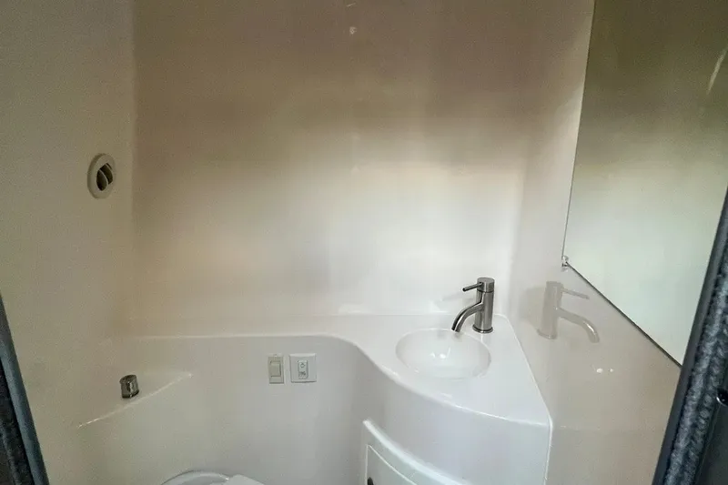 Slide: The Image of Compact bathroom in 2020 Regal 26 XO boat with modern sink and mirror. - 45