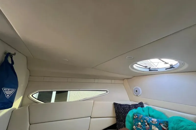 Slide: The Image of Interior cabin of 2020 Regal 26 XO boat with porthole and cushions. - 34