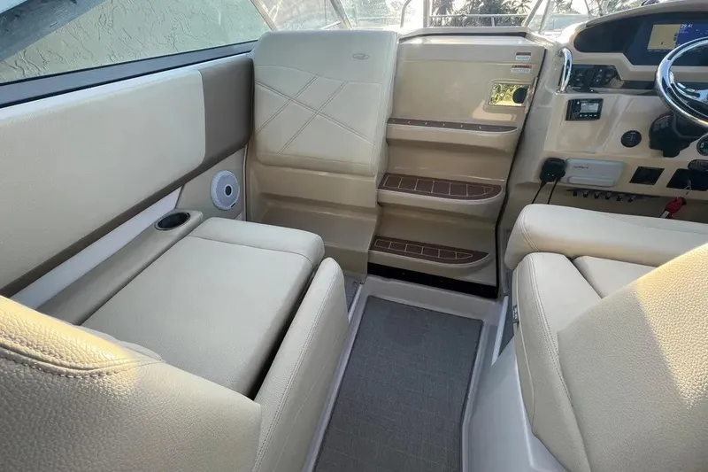 Slide: The Image of Interior of 2020 Regal 26 XO boat with beige seating and control panel. - 16