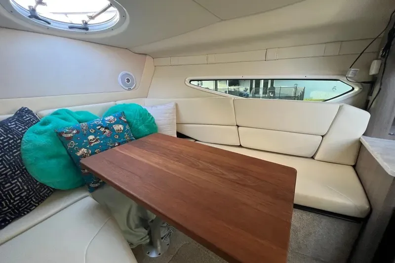 Slide: The Image of 2020 Regal 26 XO cabin interior with cozy seating and decorative pillows. - 31