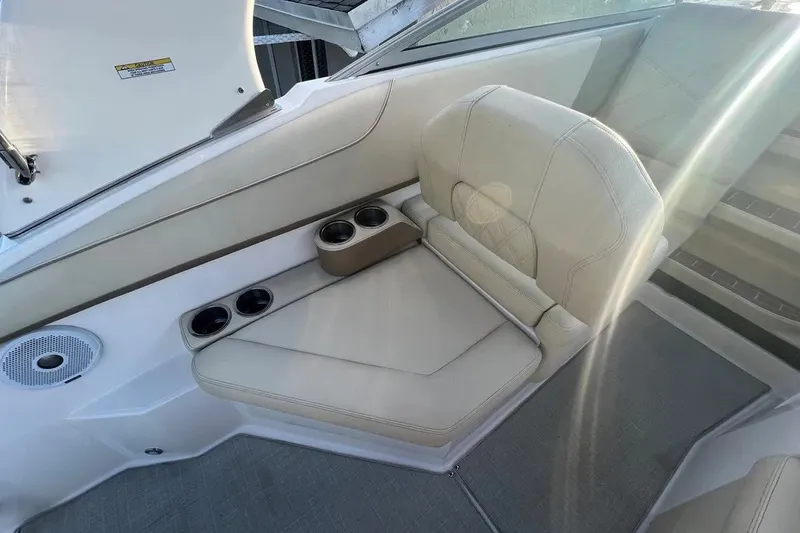 Slide: The Image of 2020 Regal 26 XO boat interior with beige seating and cup holders. - 20