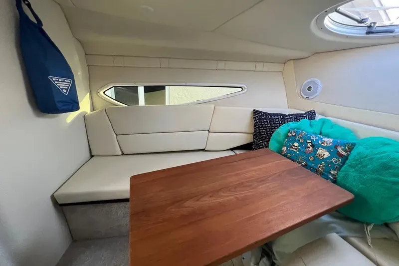 Slide: The Image of Cozy interior of 2020 Regal 26 XO boat with cushions and wooden table. - 32