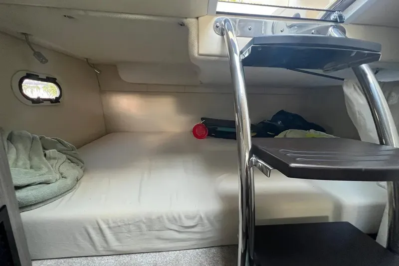Slide: The Image of Cozy cabin interior of 2020 Regal 26 XO boat with bed and ladder. - 42